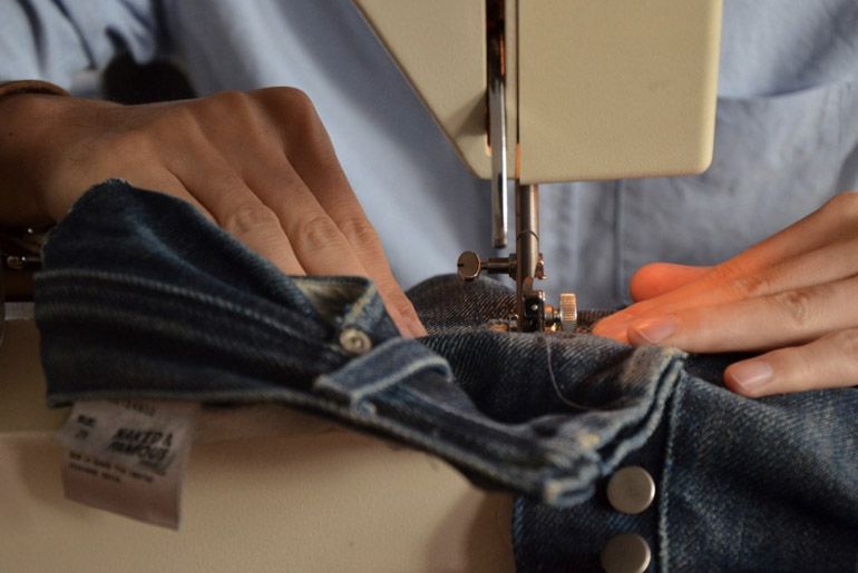 Feed the jeans and guide it through evenly!